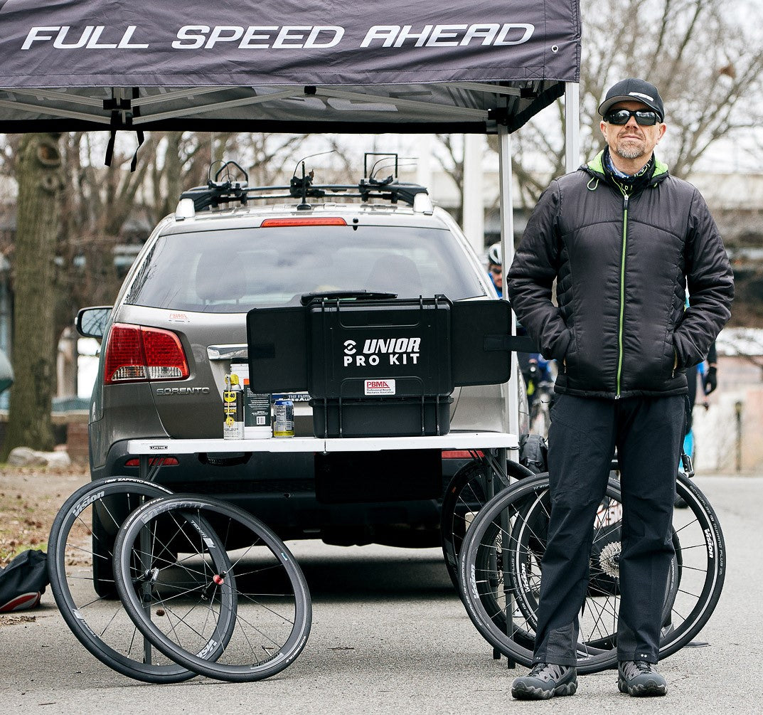 Per Rosenkvist of FSA Neutral Support standing beside a Unior Pro Kit case mounted on his support vehicle at a road race