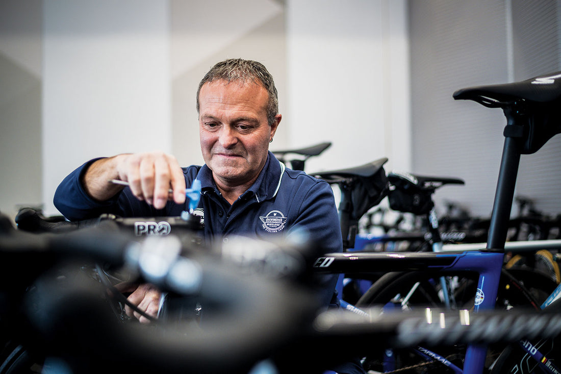 Dirk Tyteca of Deceuninck Quick-Step in the team service course, adjusting a Specialized time-trial bike cockpit