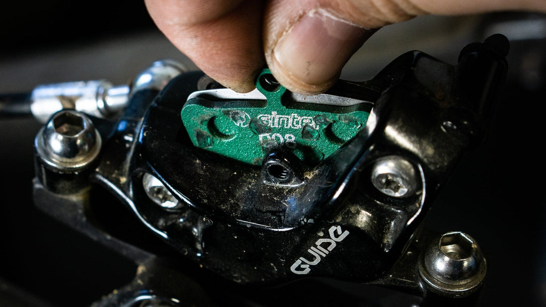 Sinter Model 008 disc brake pad being fitted into a SRAM Guide hydraulic caliper