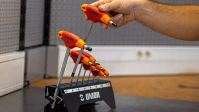 Mechanic lifting the 8 mm Unior 193HX-US T-handle hex wrench from its 2 to 10 mm stand