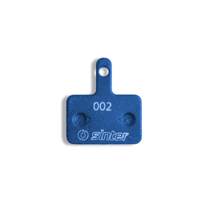 Sinter Blue 002 disc brake pad back plate with 002 model stamp and Sinter logo, fits Shimano Deore Alivio Acera B Type