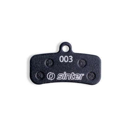 Sinter Black 003 disc brake pad back plate close-up, four damping pads around 003 model stamp for Shimano Saint Zee