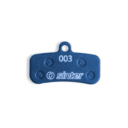 Sinter Blue 003 disc brake pad back plate close-up, four damping pads around 003 model stamp for Shimano Saint Zee
