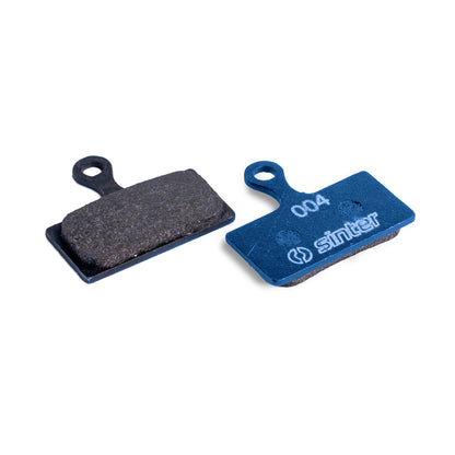 Sinter Blue s004 organic disc brake pad next to worn black pad, for Shimano XTR, XT and SLX G/L Type calipers