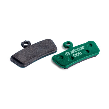 Sinter Green s008 organic disc brake pad next to worn black pad, for SRAM G2, Guide and Trail calipers