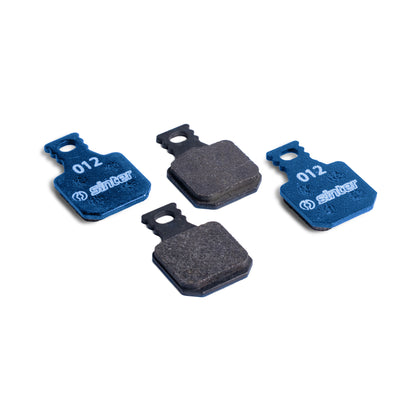 Sinter Model 012 Magura blue organic brake pads, four pads showing blue backplates stamped 012 and dark friction surfaces