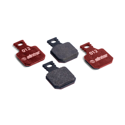 Sinter Model 012 Magura red organic brake pads, four pads showing red backplates stamped 012 and dark friction material
