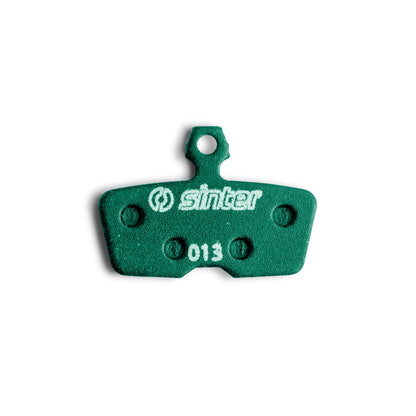 Sinter Green s2032 disc brake pad close-up for SRAM Code and Avid, model 013 stamped on backing plate