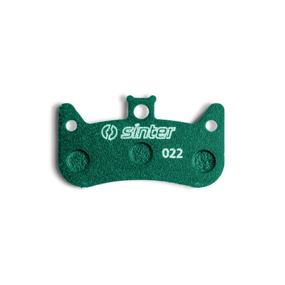 Sinter Model 022 disc brake pad close-up in green race compound, four-piston pad stamped 022 for Formula Cura 4