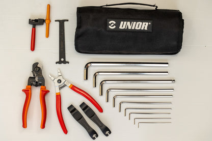 BMX Kit Roll Set 1600BMX-ROLL contents laid out beside the closed Unior canvas bag, hex keys and pliers visible