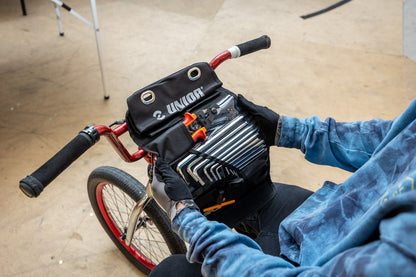 BMX rider seated with the Unior BMX Kit Roll Set 1600BMX-ROLL mounted on the handlebars, hex keys visible
