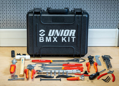 BMX Tool Kit 1600BMX closed case with the full 27-tool layout arranged on a workbench in front of it
