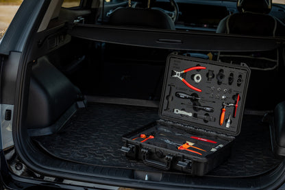 Unior BMX Tool Kit 1600BMX open in the cargo area of a hatchback, tools cradled in foam ready for trackside