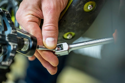 Mechanic using Unior Speed Pedal Wrench 1613S/1BI to install an 8 mm hex clipless pedal on a mountain bike crank