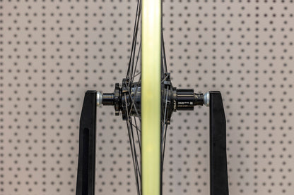 Rear bicycle wheel held in Unior truing stand by 1689.3 axle adaptors, Cinelli Vault hub seated between the cones