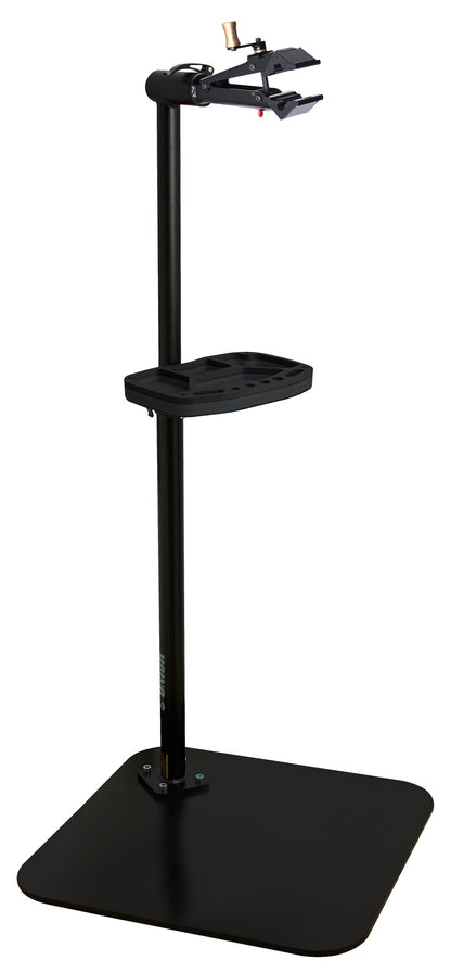 Unior single-arm professional repair stand in black, quick-release clamp head and tool tray on a square steel base