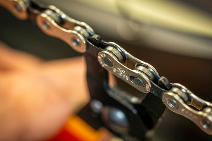 Close-up of a SRAM chain master link held in place, the target connector that Master Link Pliers open