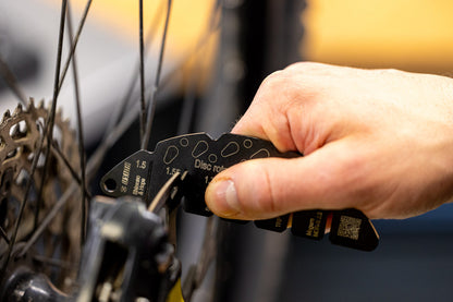 Hand fitting Unior Rotor Wear Indicator onto a mountain bicycle disc brake rotor to verify minimum thickness wear limit