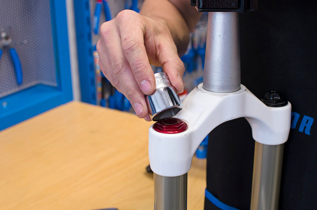 Unior 1783/1 6P flat socket being seated on a suspension fork's low-profile top cap