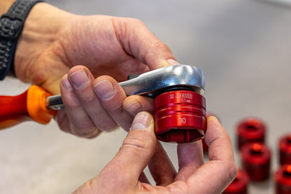 Unior 1783 Suspension Top Cap Socket size 30 driven by an orange-handled ratchet in a mechanic's hands