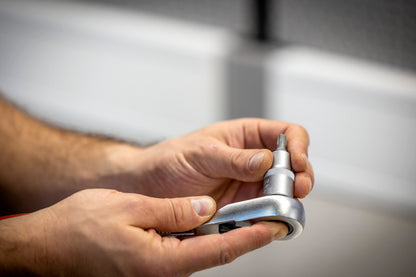 Mechanic loading the Unior 192/2TXP TX Plus socket onto a 1/2-inch ratchet handle in the workshop