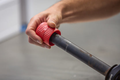 Unior 363A tube reamer placed over a cut tube end, twisting to remove interior and exterior burrs