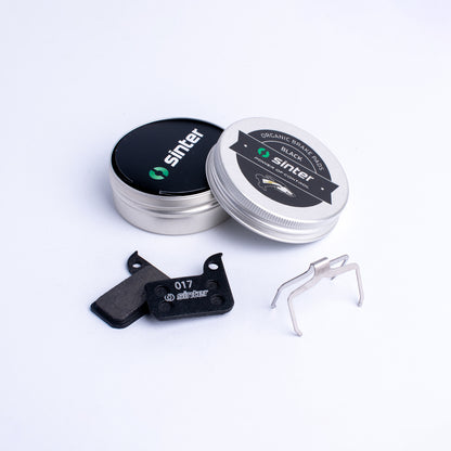 Sinter Black 017 organic brake pads with stainless spring clip and aluminum storage tin, SRAM road fit