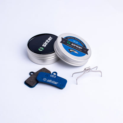 Sinter Blue 003 organic brake pad pair with aluminum storage tin and stainless spring clip for Shimano Saint and Zee
