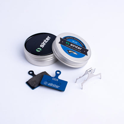 Sinter Blue 004 organic brake pads in pair with aluminum storage tin and stainless spring clip for Shimano XTR XT SLX