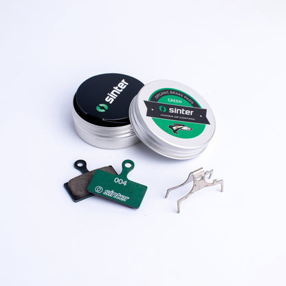 Sinter Green 004 organic brake pads with aluminum tin lid showing greyhound emblem and stainless spring clip