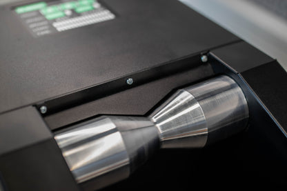 Sinter Smart Bedding Machine close-up of two polished steel hourglass rollers that spin the bicycle wheel during pad bedding