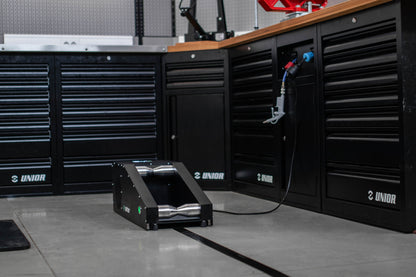 Sinter Smart Bedding Machine on a workshop floor with polished steel rollers, set among Unior tool cabinets