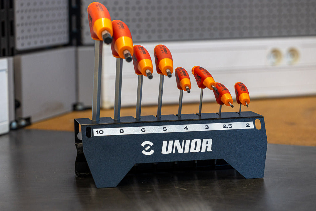 Unior 193HX-US.1 T-handle hex wrench set on the bench, eight red-and-orange wrenches in a labeled metal holder marked 10 through 2 mm