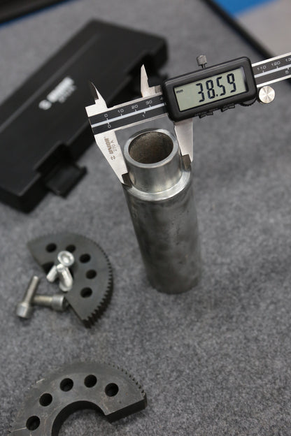 Unior 270A digital caliper measuring a steel tube outer diameter 38.59 mm on a workshop bench