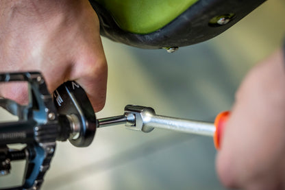 Unior Speed Pedal Wrench 1613S/1BI with the swivel handle set at 90 degrees, driving the hex in a clipless pedal spindle behind the crank arm