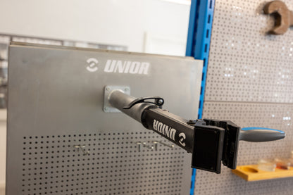 Mountain bike suspension fork being bled with oil syringe inside the Unior 990SIN stainless steel suspension sink