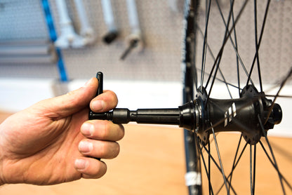 Unior Hub Genie 1758/4 seated in a bike's thru-axle hub, its expanding collet gripping the end cap from inside to pull it straight out.
