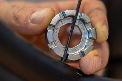 Unior Round Spoke Wrench 1631/5 engaged on a spoke nipple at the rim while truing a bicycle wheel