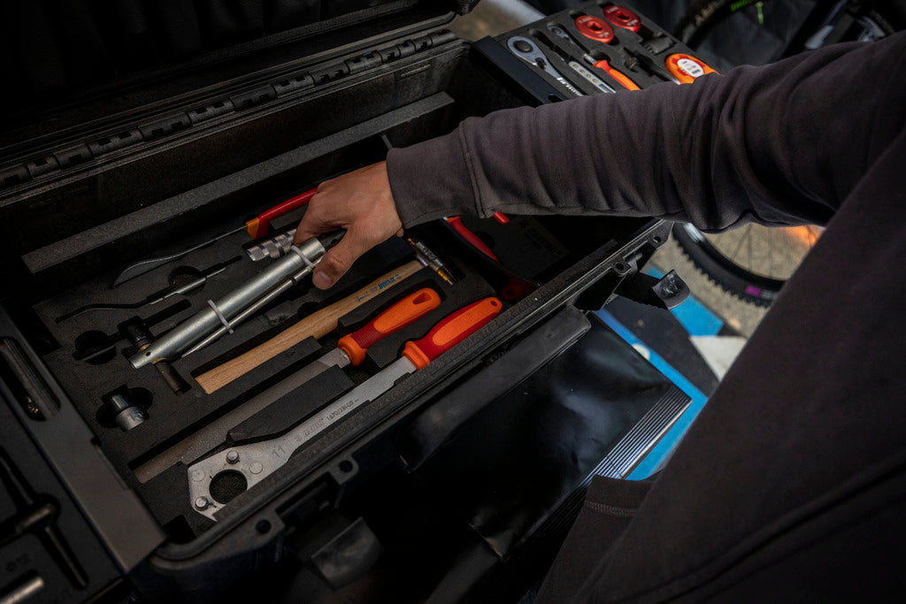 Mechanic lifting a tool from the Master Tool Kit 2.0 bottom foam tray trackside - 1600MASTERKIT