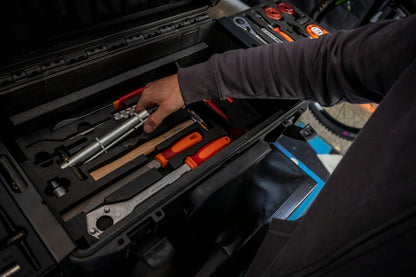 Mechanic lifting a tool from the Master Tool Kit 2.0 bottom foam tray trackside - 1600MASTERKIT