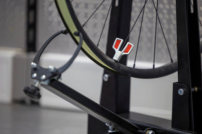 Unior Professional Spoke Wrench 3.45 engaged on a road wheel nipple in a truing stand, orange head visible