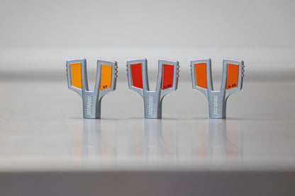 Three Unior professional spoke wrenches lined up: yellow DT, red 3.30, orange 3.45 sizes for J-bend nipples