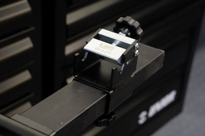 Unior Thru-axle Adaptor 1693R.2 fitted to a Pro Road Stand rail in front of black workshop tool cabinets