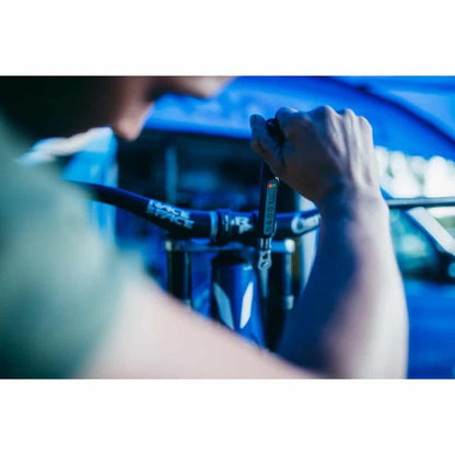 Mechanic using Unior 266B electronic torque wrench on a Race Face mountain bike cockpit at the race-day truck
