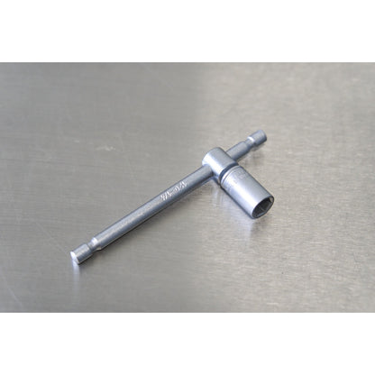 Unior 1/4-inch T-handle socket wrench on a metal surface, slim chrome shaft with quick-drive hex end