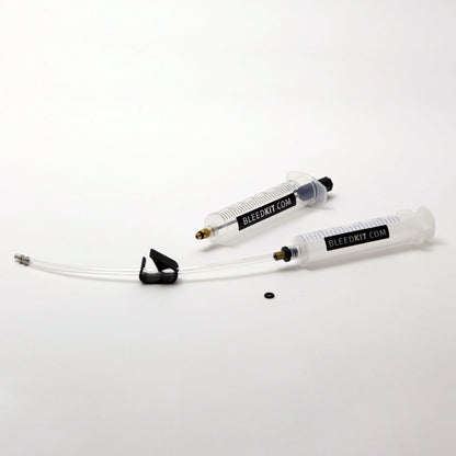 Bleedkit Basic kit overview for Shimano brakes, two Bleedkit syringes and bleed tube laid out on a white surface