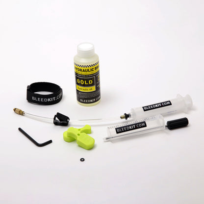 Bleedkit Premium Gold Magura MT bleed kit laid out, mineral-oil bottle, syringes joined by hose, green pad spacers