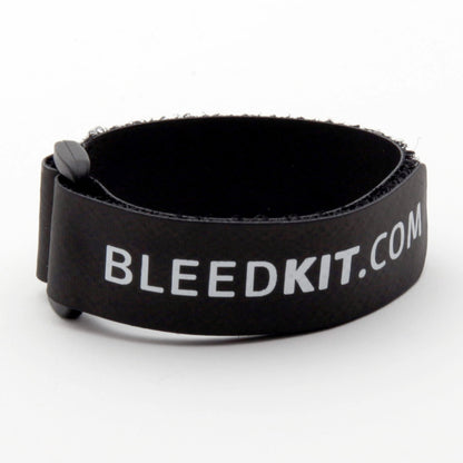 Bleedkit black hook-and-loop hose strap with white BLEEDKIT.COM logo, coiled to secure brake line during bleed