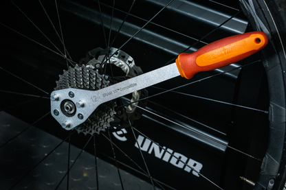 Unior Cassette Wrench X Range in use on a SRAM 1X cassette and rear wheel, lockring engaged for removal