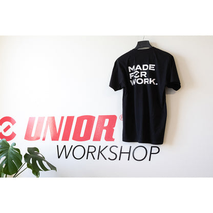 Made For Work tee shirt rear print in white reading Made For Work on a black shirt, hung against a Unior Workshop mural wall